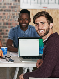 two executive working in a small office and smiling