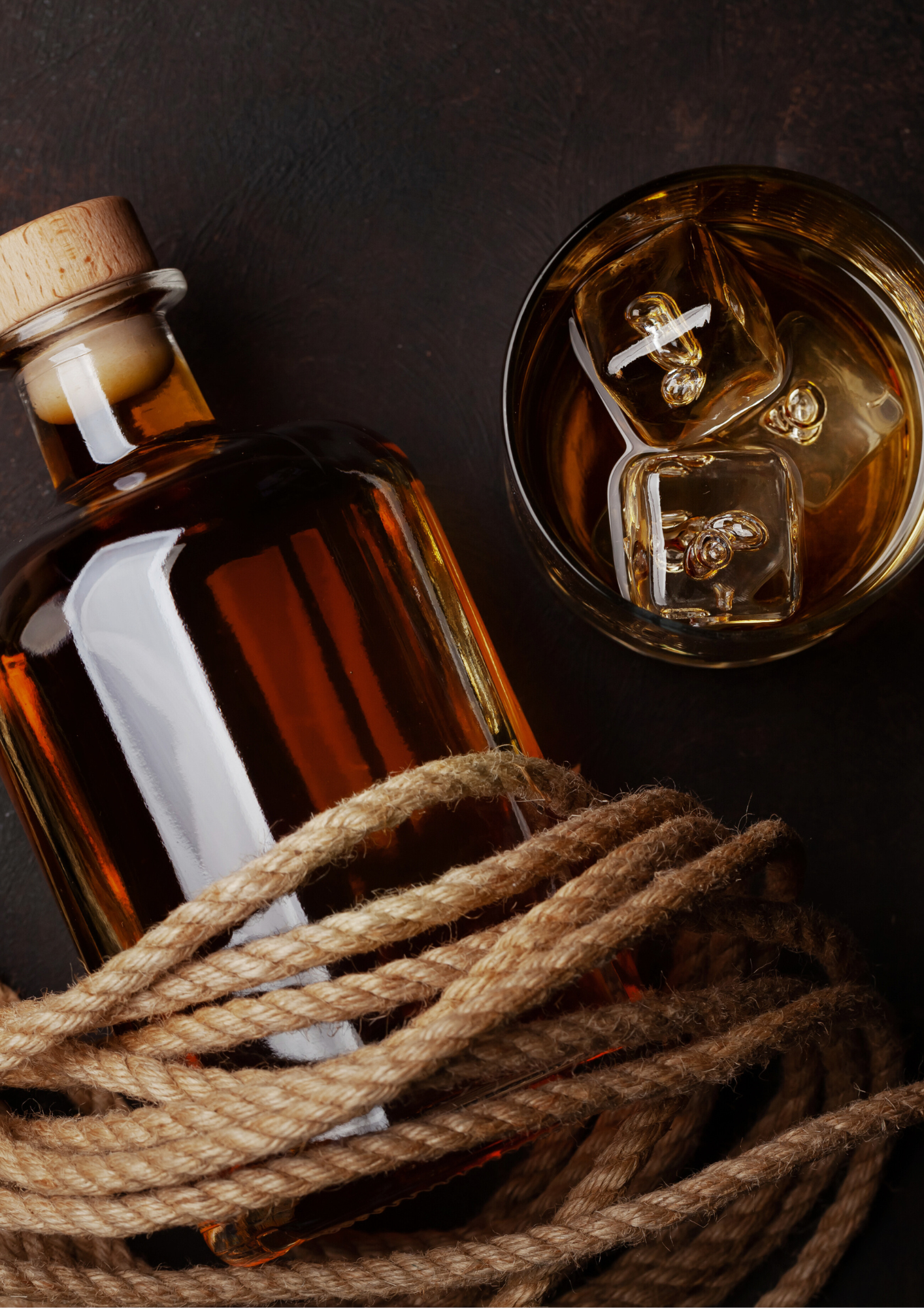 A bottle of rum with a glass