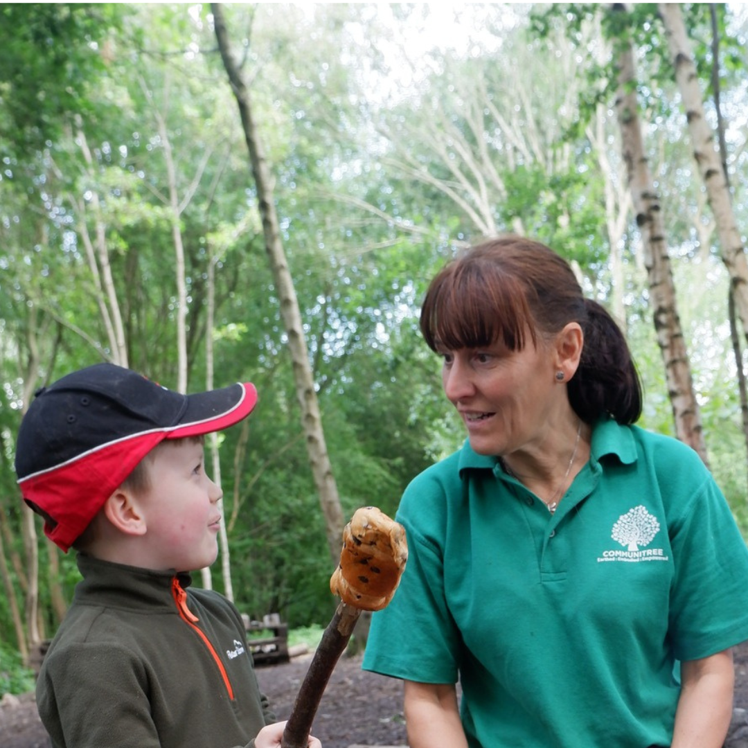 Carolyn from Communitree with child toasting brioche
