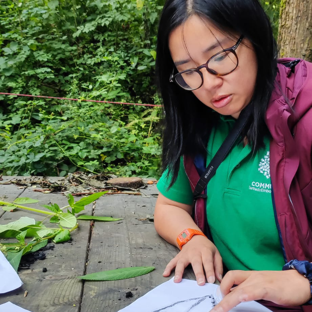 Tina from Communitree blending charcoal on a piece of paper