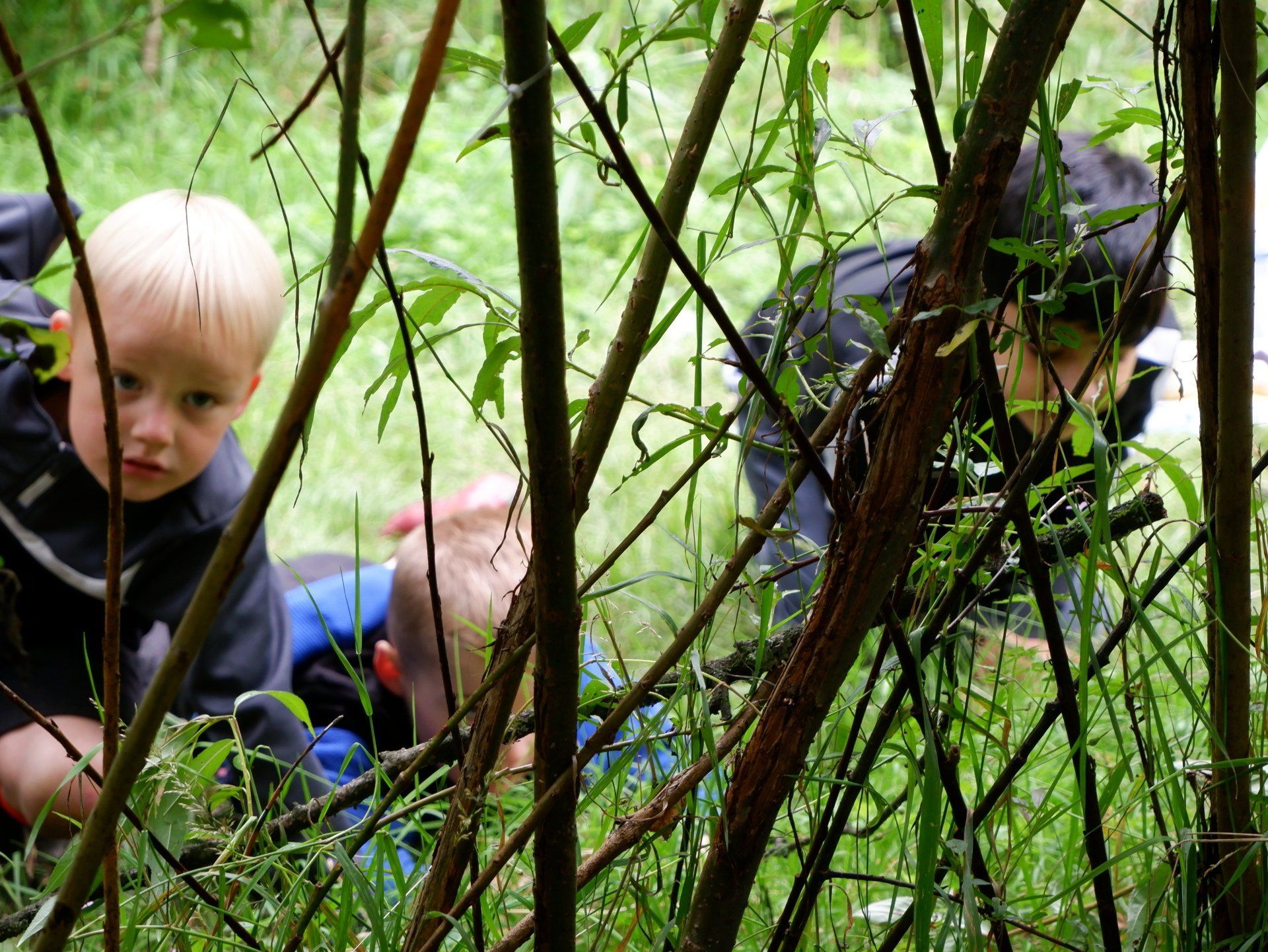 Three boys at Summerseat holiday club hiding in the long grass