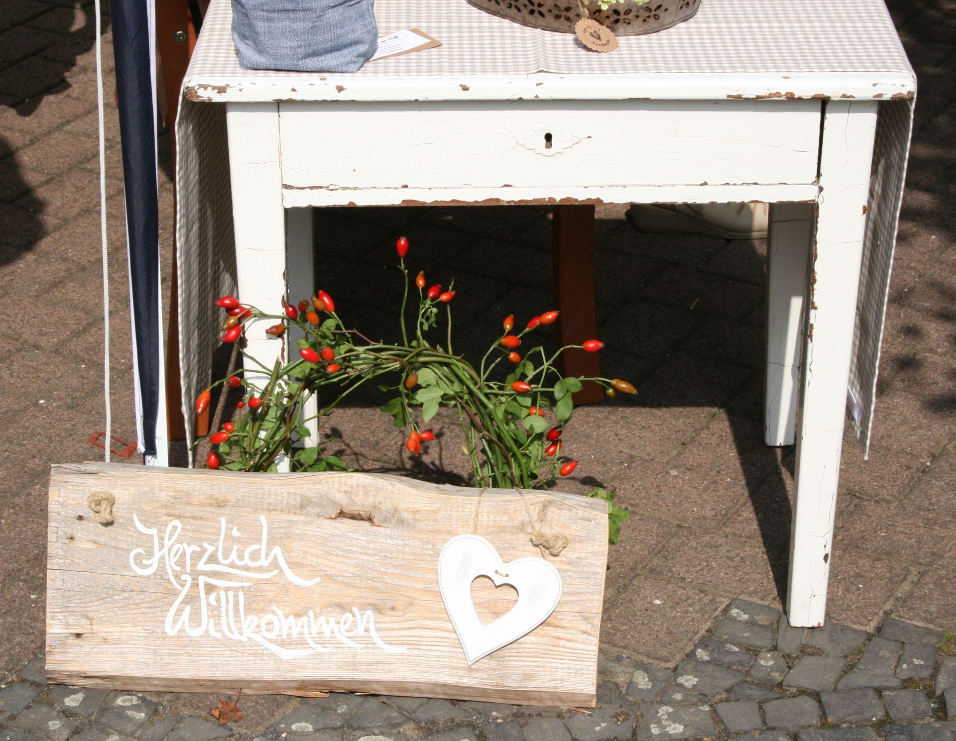 Dekoschild mit dem Schriftzug,„ Herzlich Wilkommen