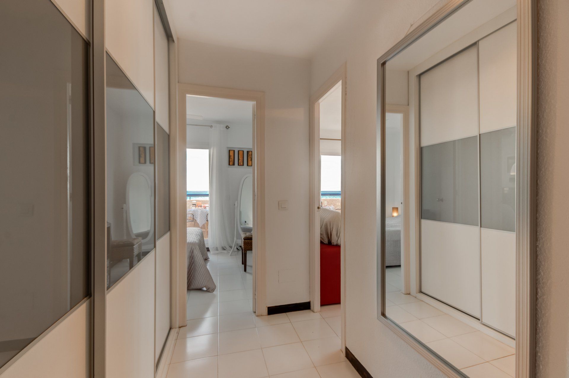 entrance hallway with open doors into the bedroom and living room