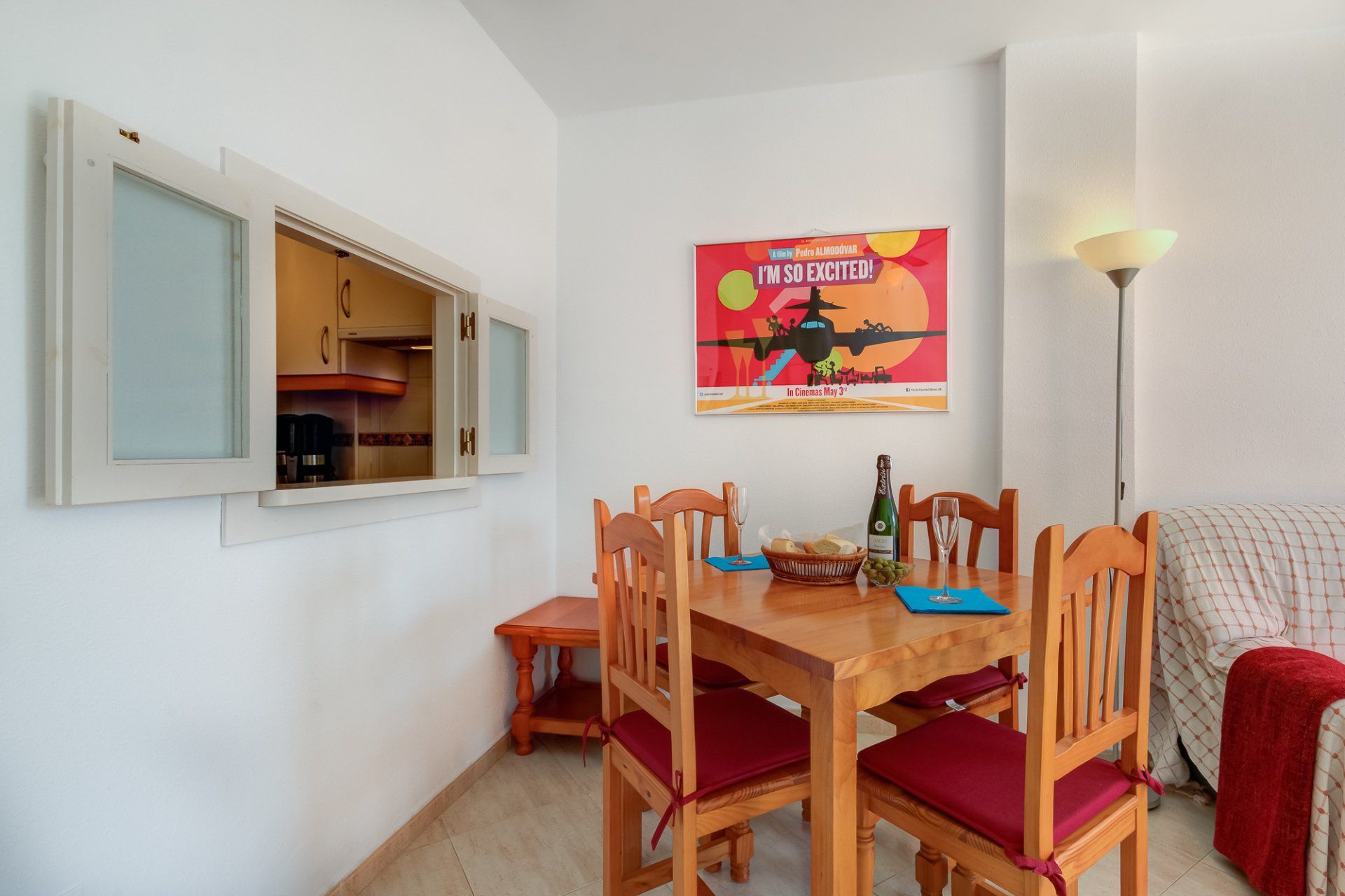 dining area with pine table and four chairs with red seat pads