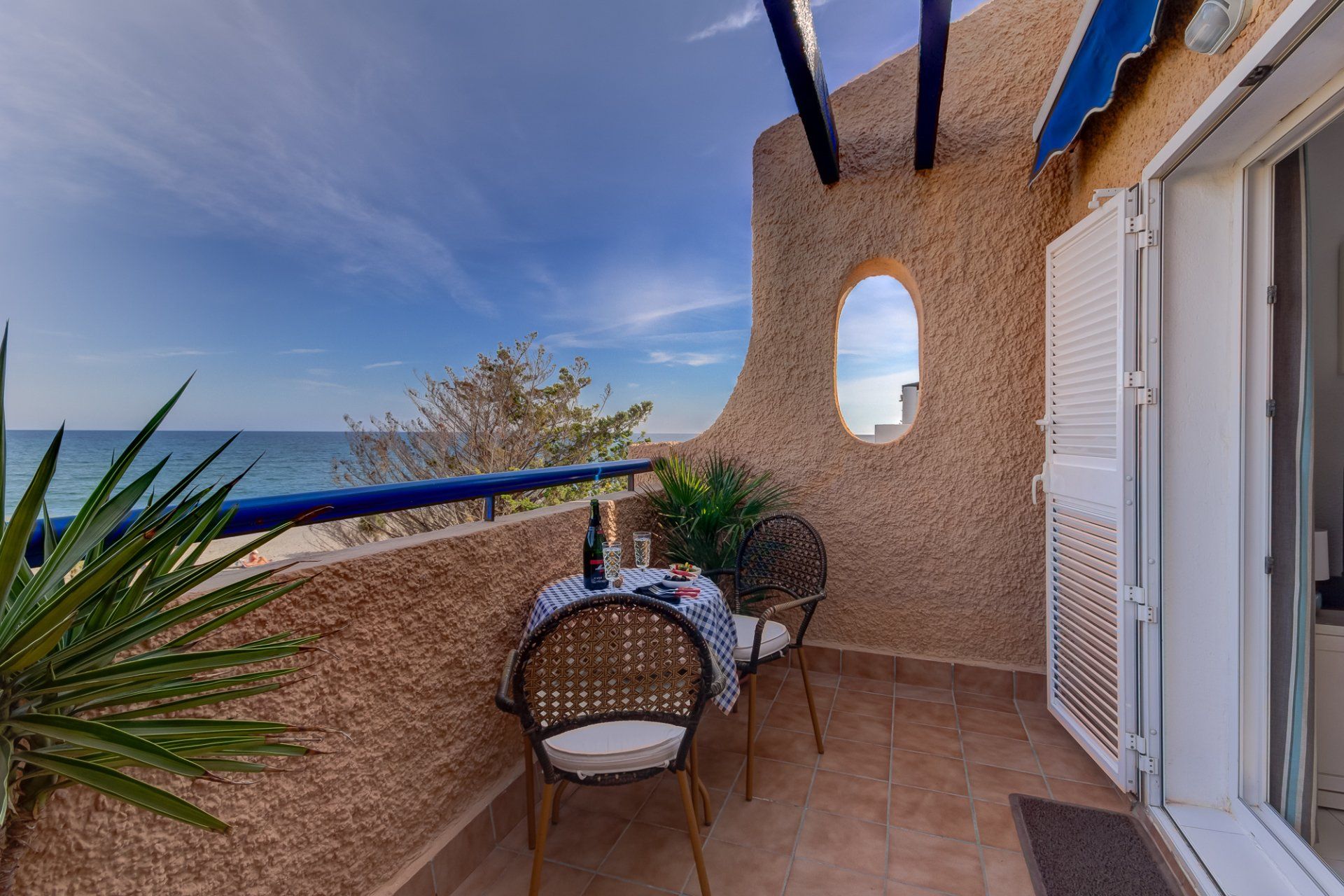 small terrace with bistro table and chairs and views of the sea