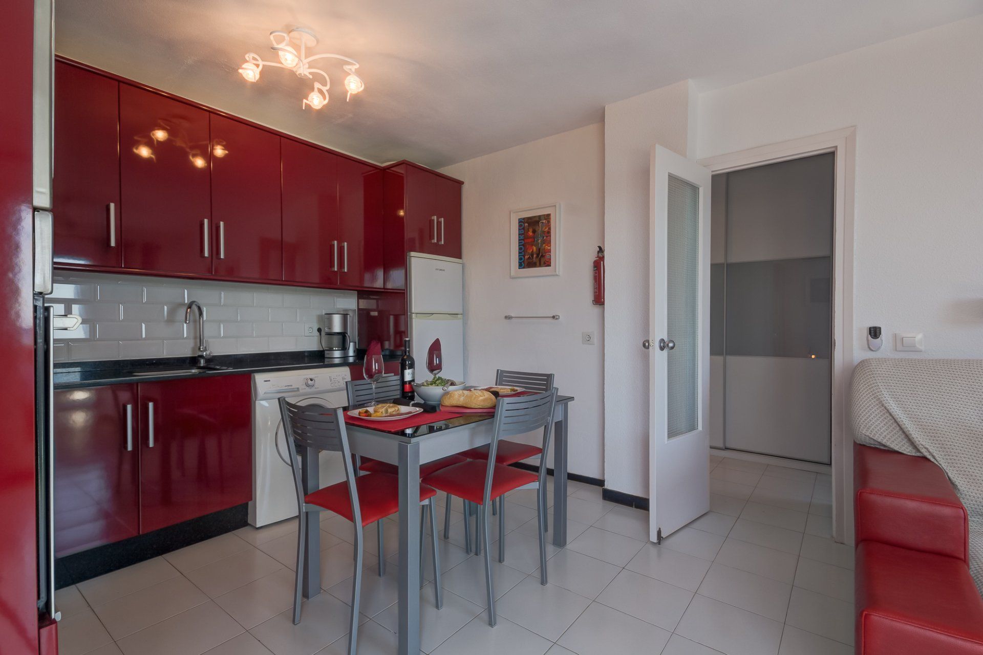 middle part of the room with the lounge area on the right and the kitchen to the left