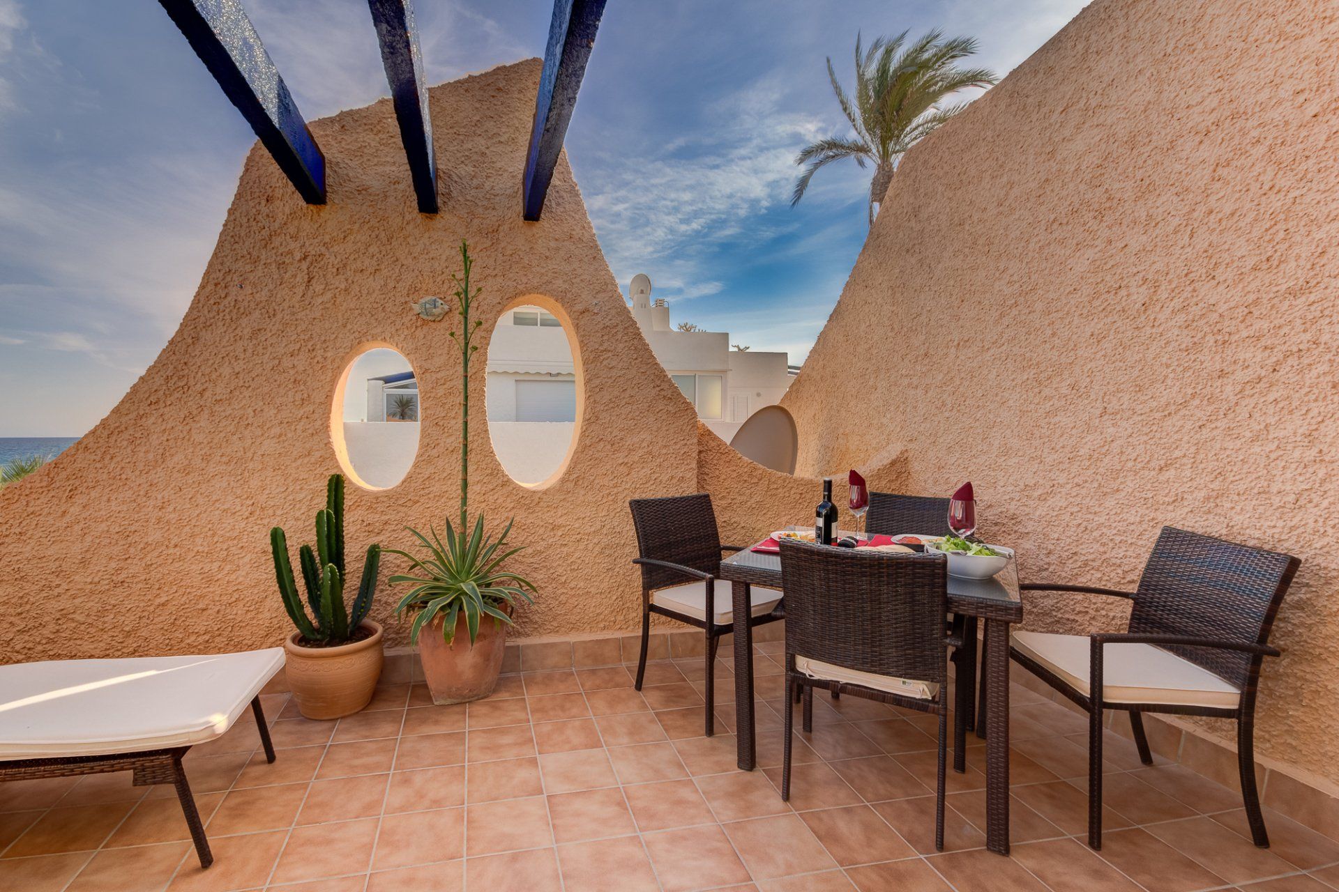 looking down the middle of the main terrace with the table on the right and the sunloungers on the left