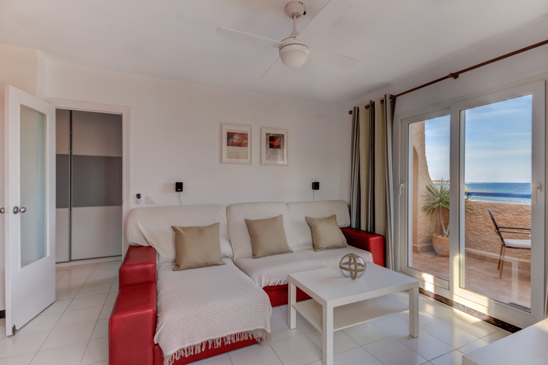 this lounge end of the room with big comfy looking sofa and coffee table