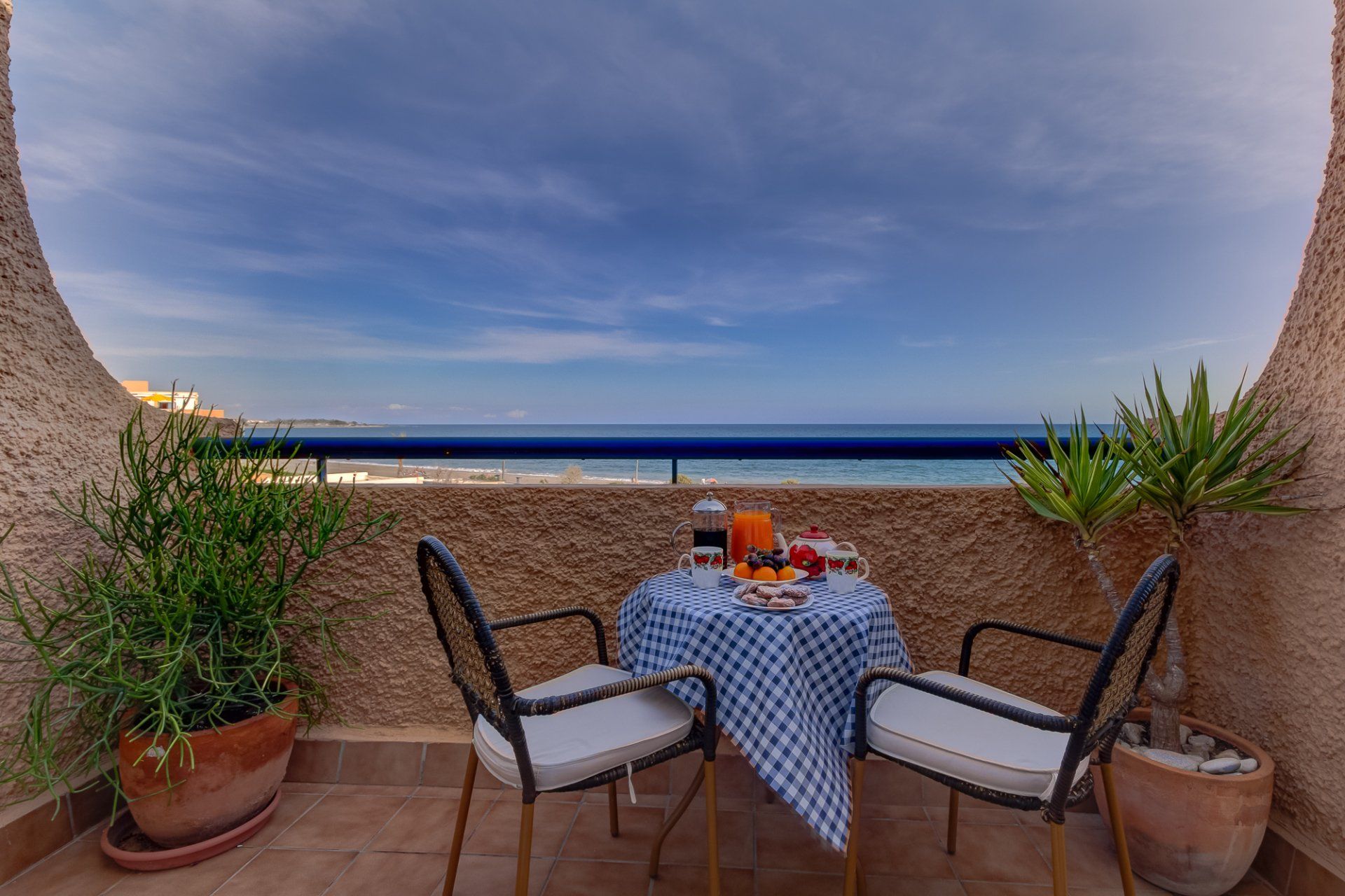 on the terrace with a bistro table and chairs and a sea view