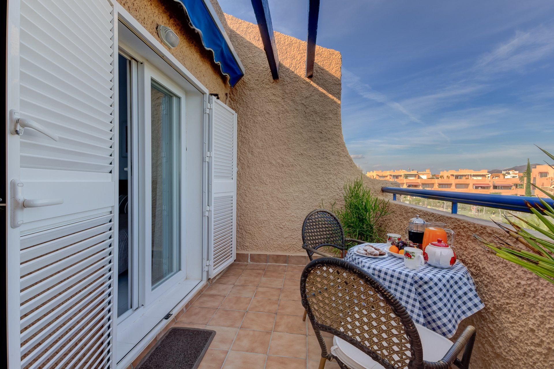 the small bedroom terrace with a bistro table and chairs with cava and tapas