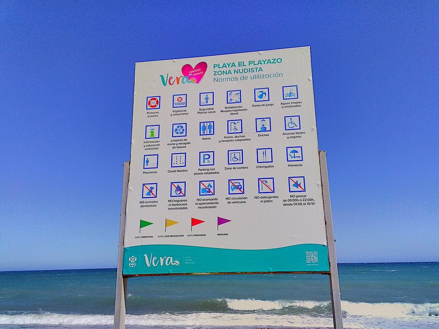 a big sign explains the norms and rules of the naturist beach