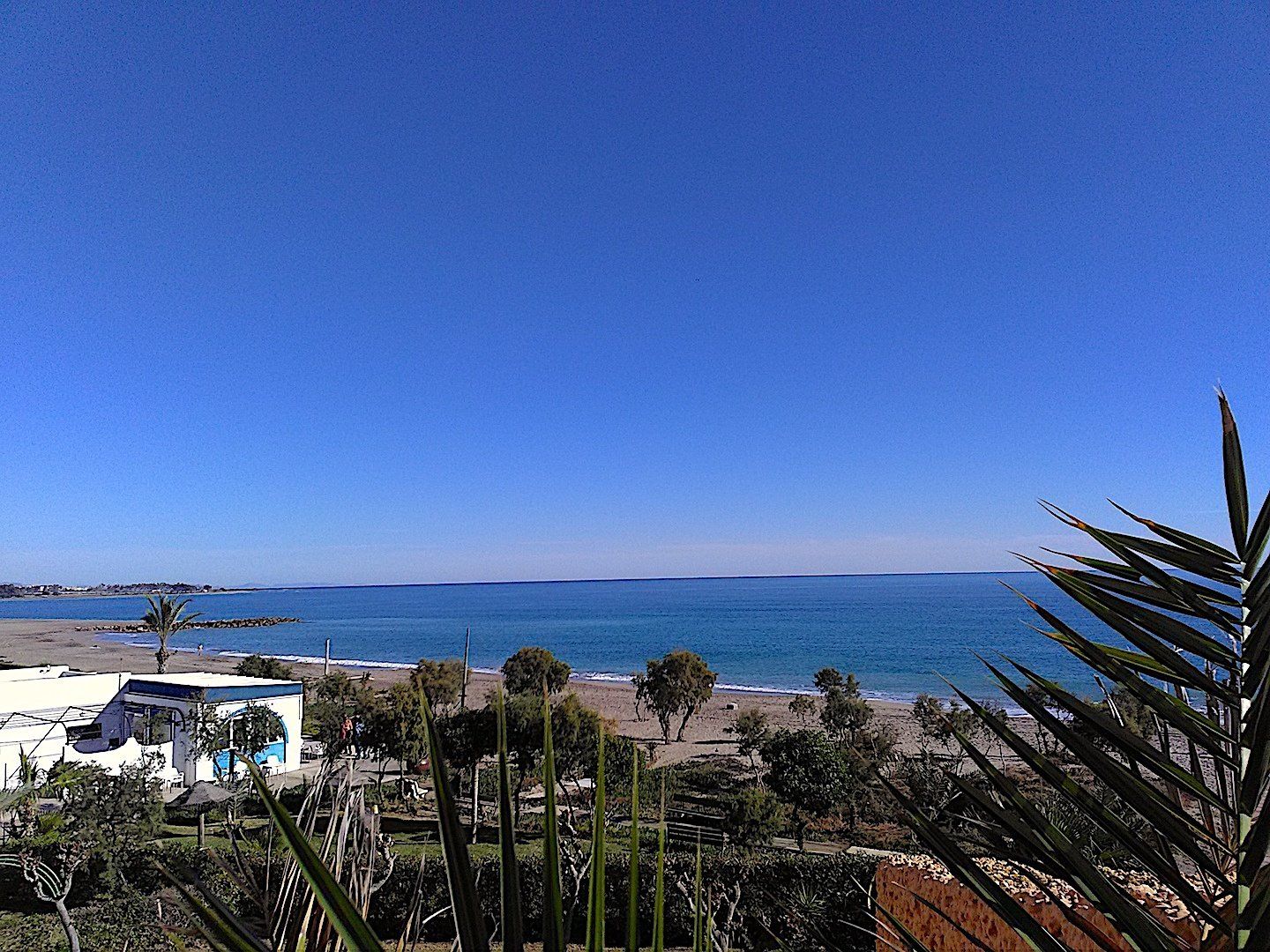 looking over the terrace and to the beach below on a quiet day with no one on the beach