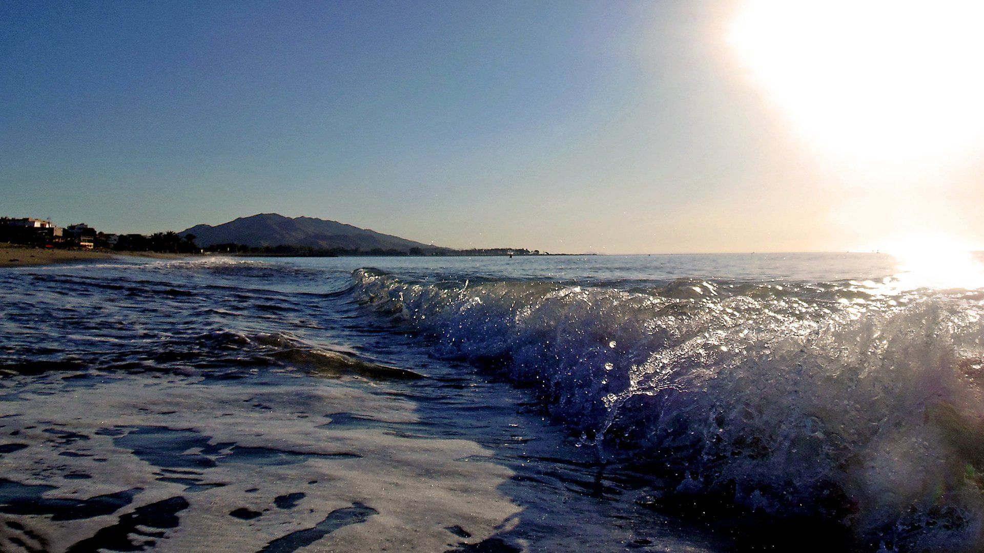 a close up of rolling surf as it meets the shoreline