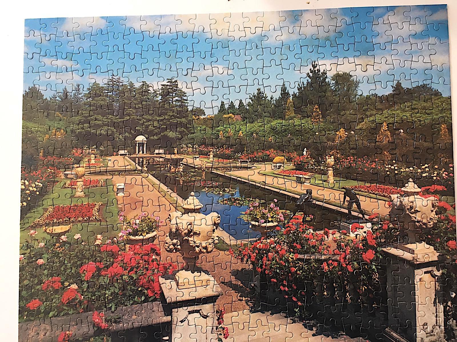 a finished jigsaw puzzle of ornate gardens and pond
