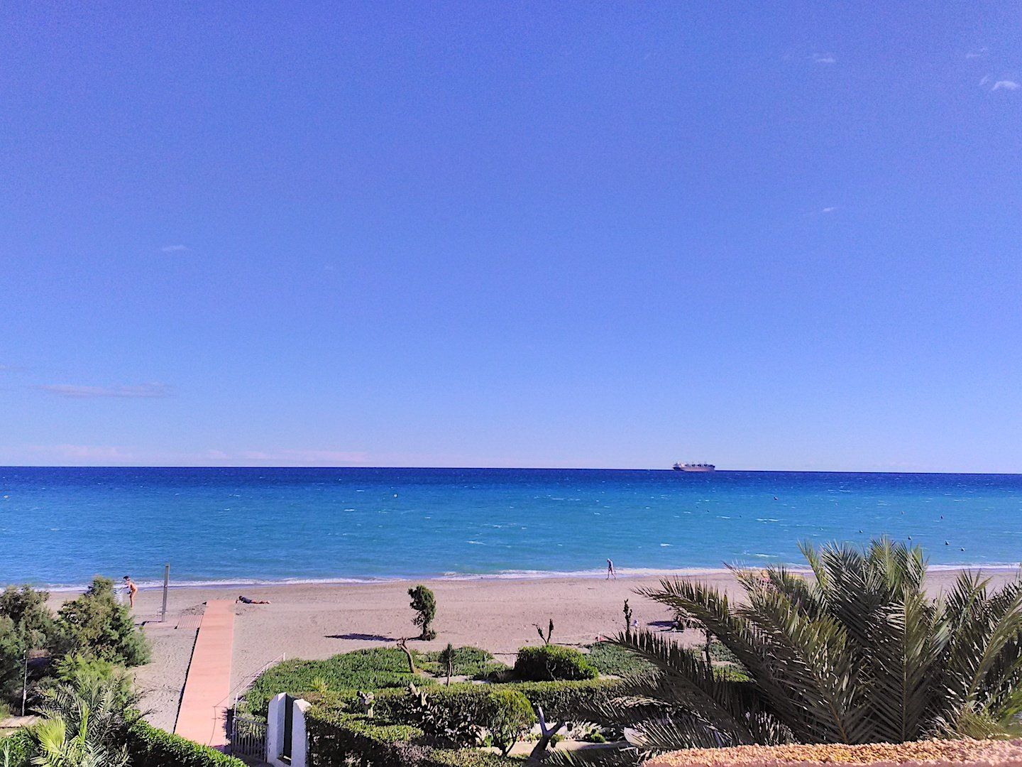 looking over the terrace and to the beach below on a quiet day with no one on the beach