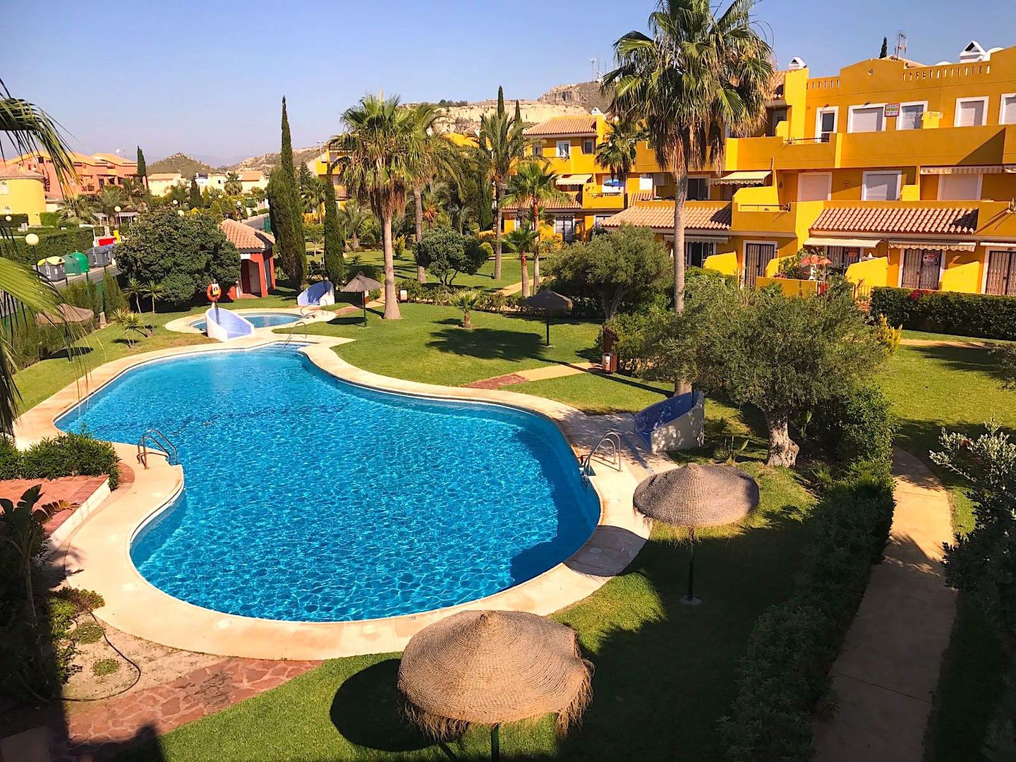 looking down onto the blue swimming pool from above