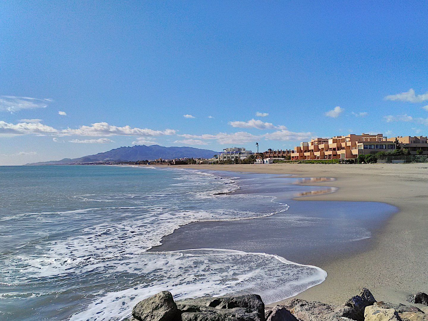 taken from some rocks and looking across the water and along the coast line of the naturist beach