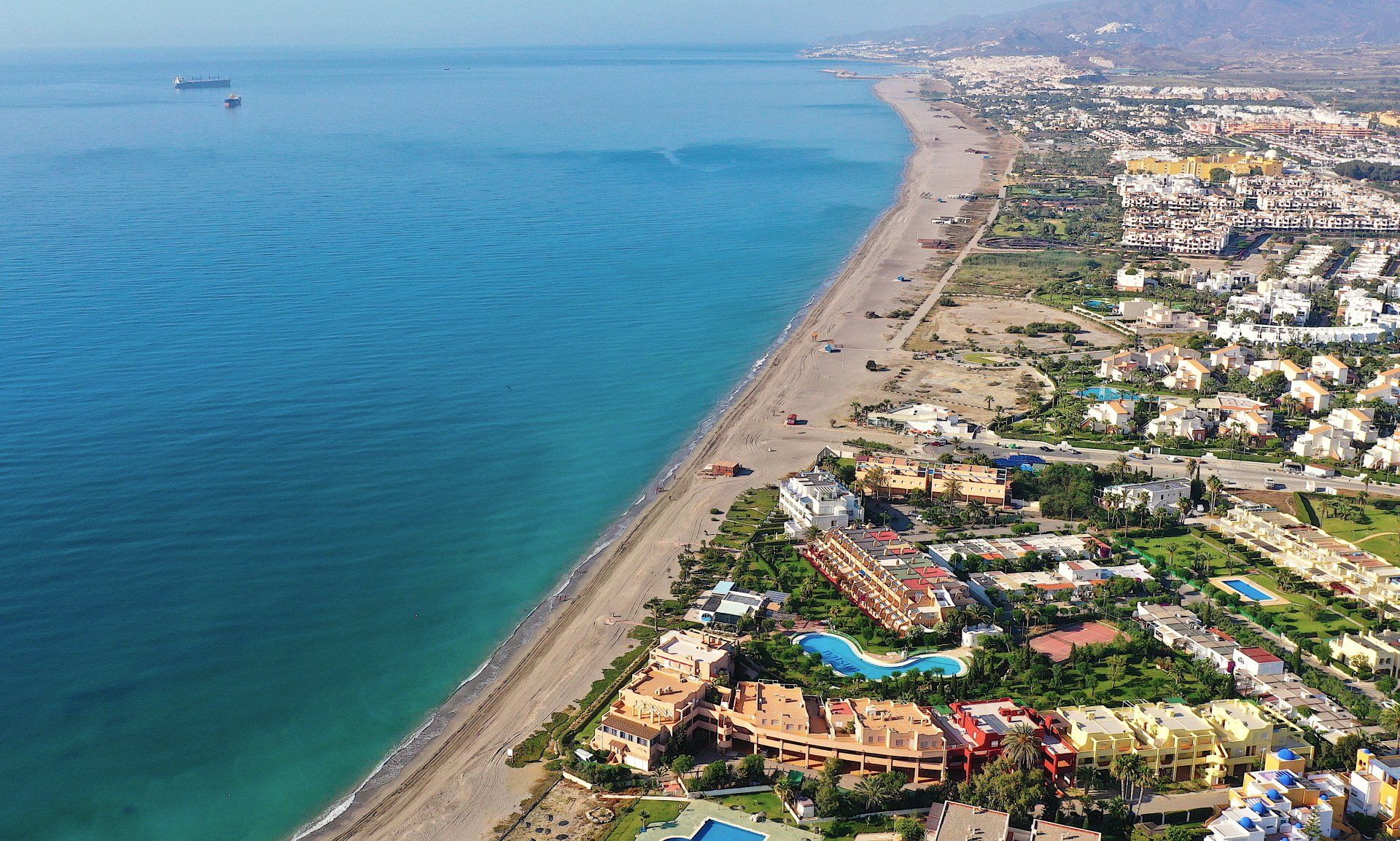 Arial view of the resort looking down on the beach side apartments the beach and the blue sea