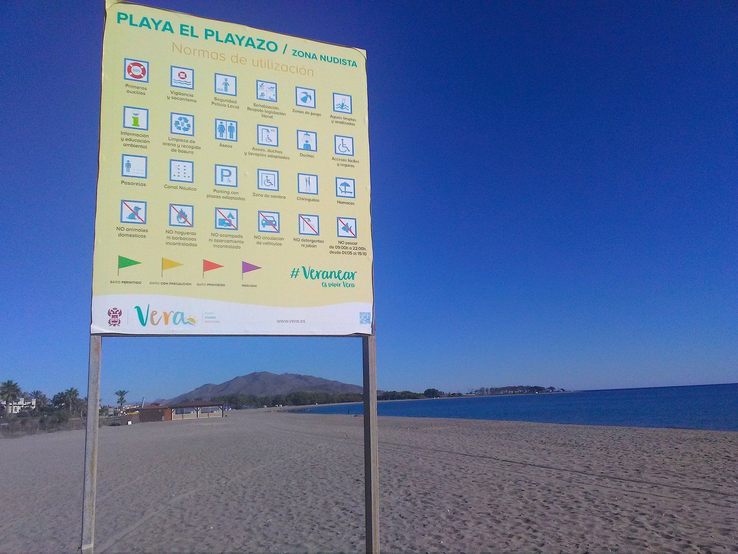 the official zona nudista sign on the vera playa beach outlining the norms of use