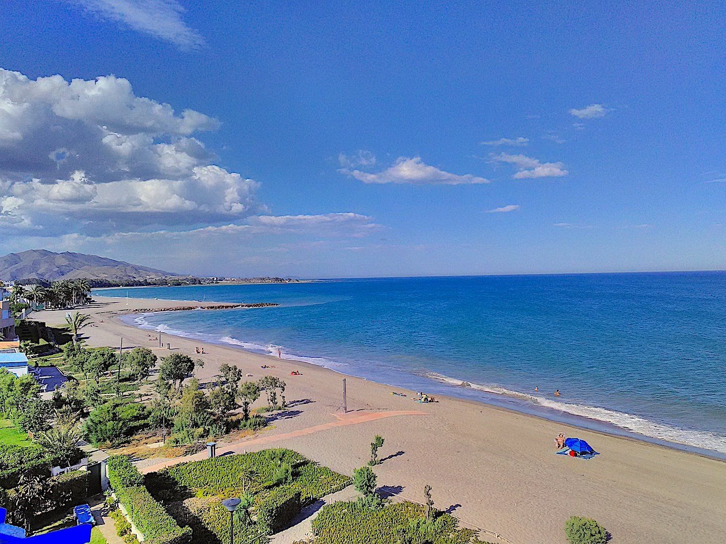 the naturist beach vera playa on a warm and sunny day with people dotted about