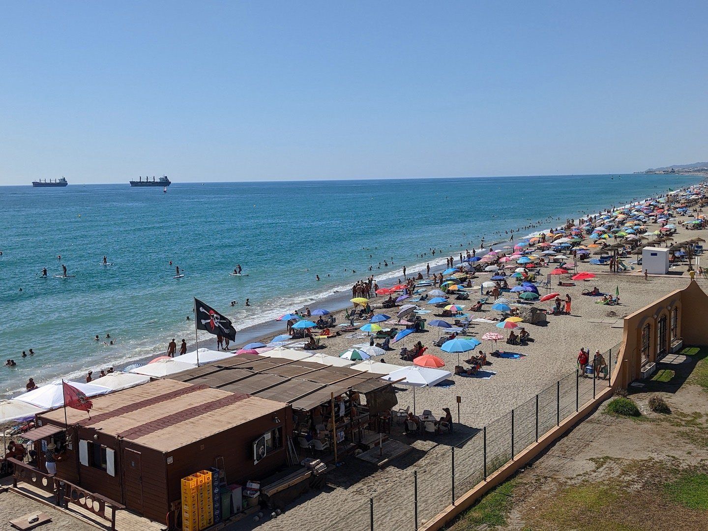 a busy beach with lots of people on it