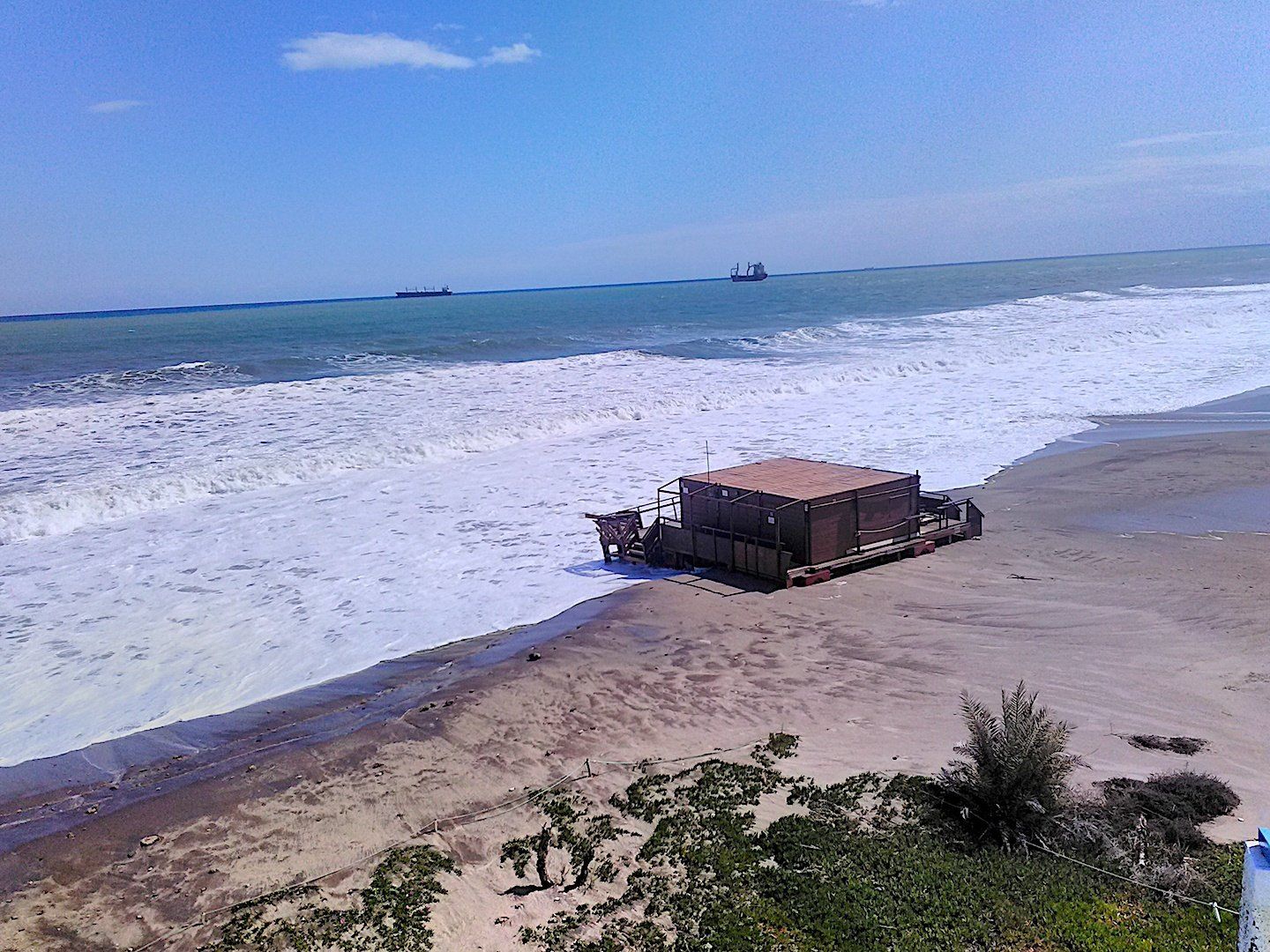a winter time photo of a beach bar engulfed in stormy water during a storm