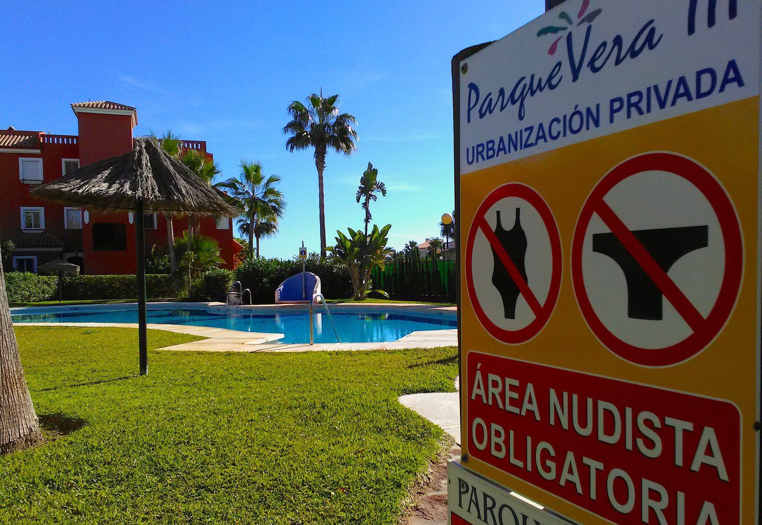 entrance to the swimming pool area with a sign that says no swimwear