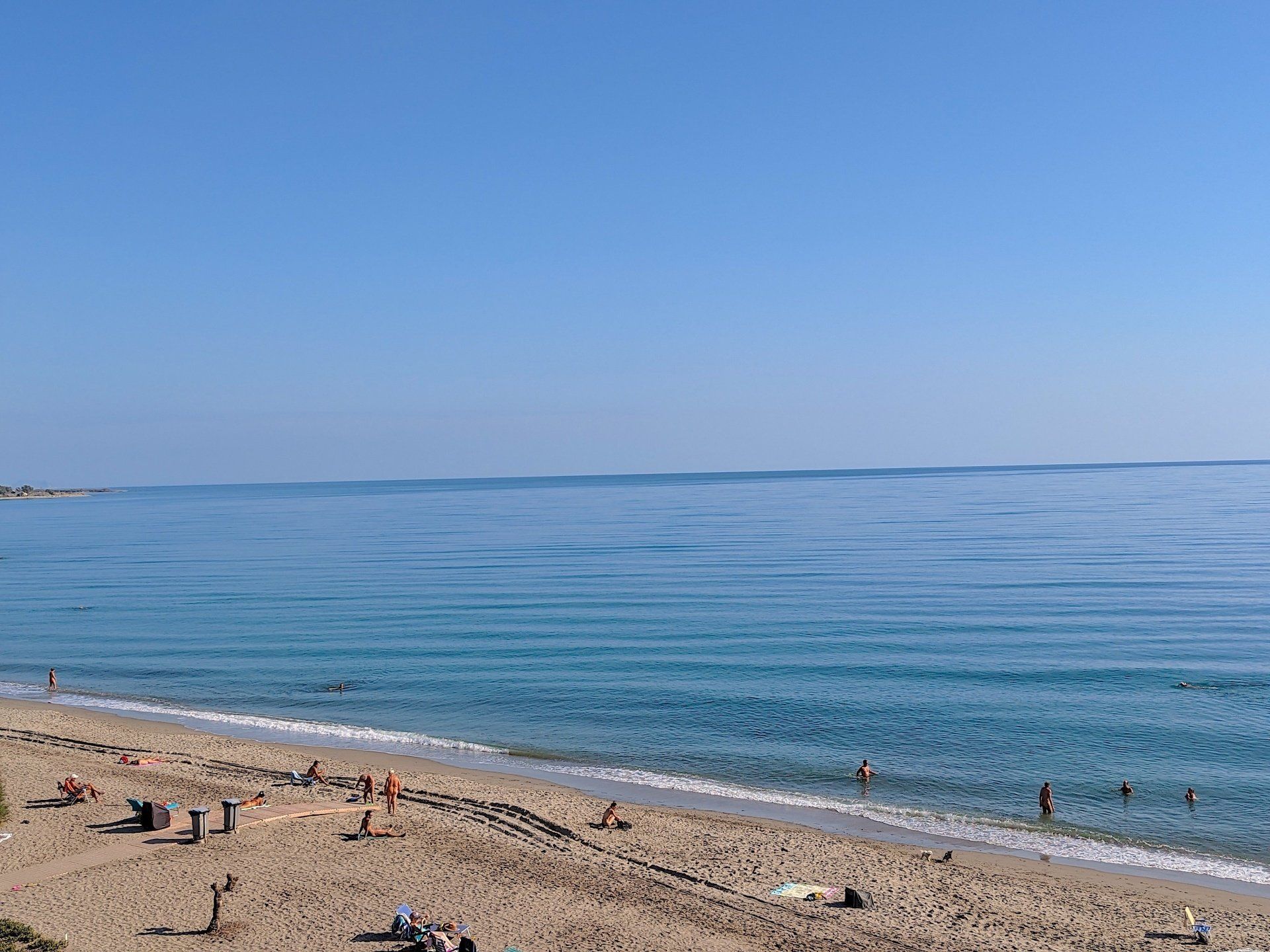 people enjoying the sandy beach and the sea looks warm and inviting