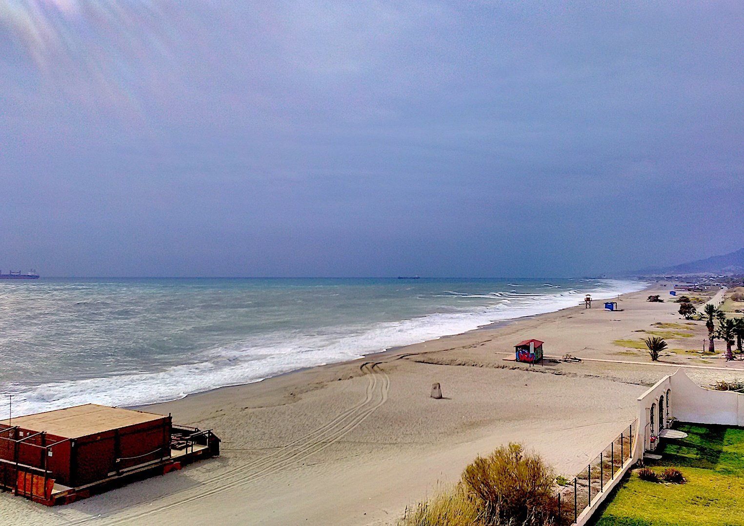 view from above of the naturist beach but not a soul in sight and the sea is looking choppy