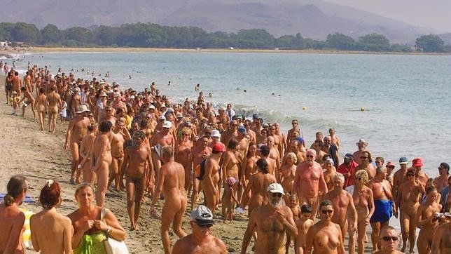 the vera playa naturist beach in high season with lots of people on the sand