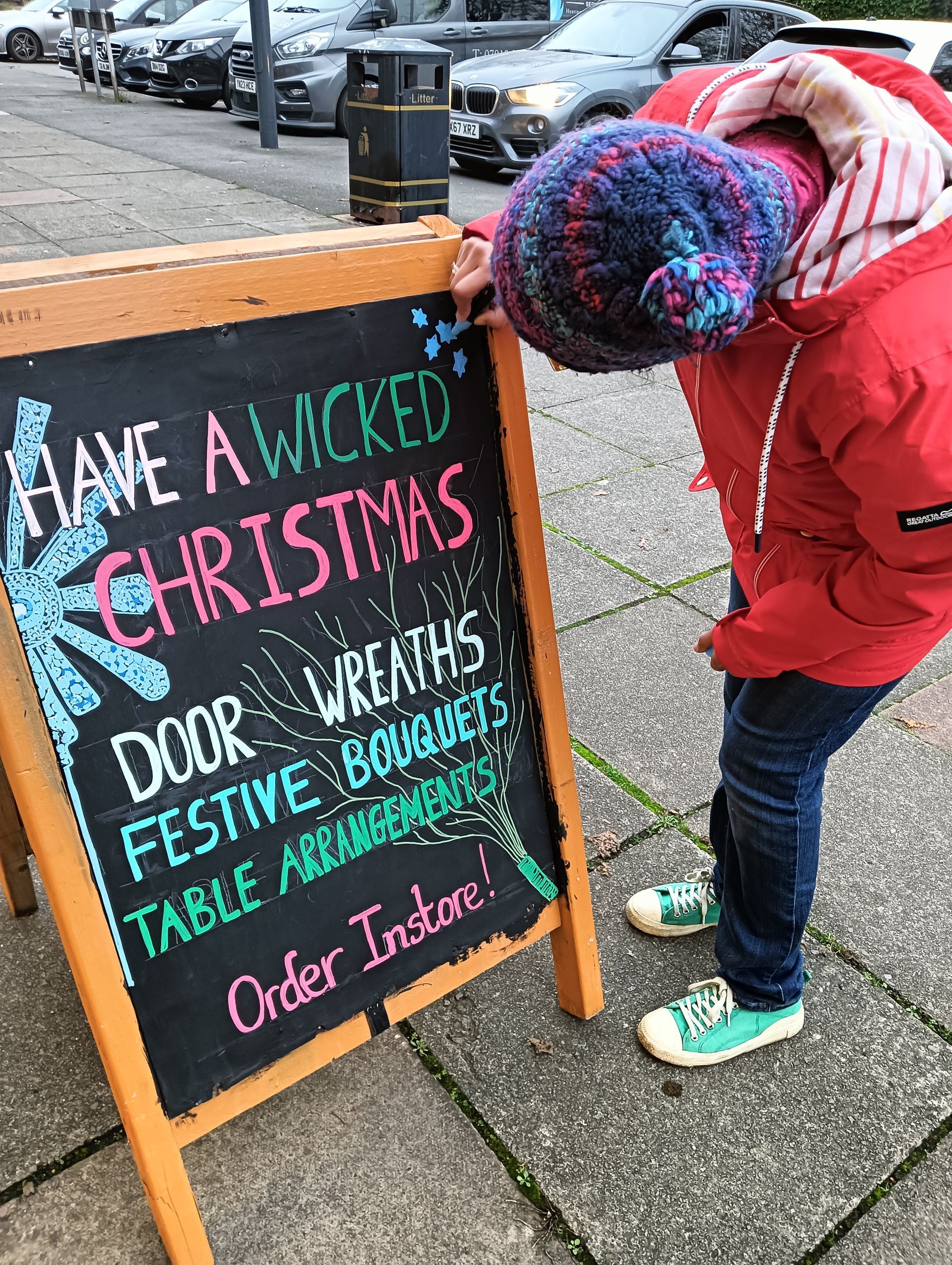 Chalk Board Art illsutratrating that shows a blue wand and broomstick in the background with a message that reads , 'Have a Wicked Christmas!'