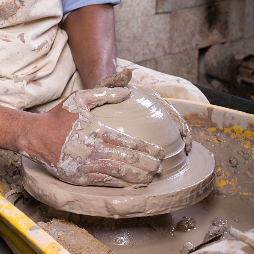 throwing pottery on a potter's wheel