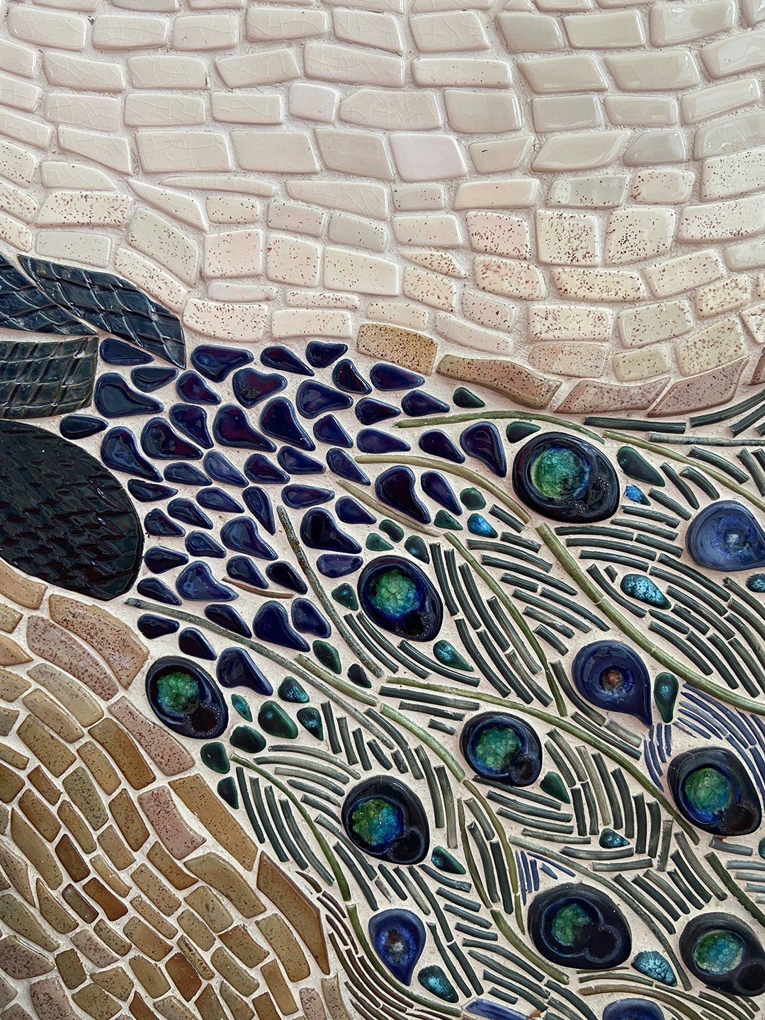 close-up view of a peacock ceramic mosaic by Gabrielle Dudley