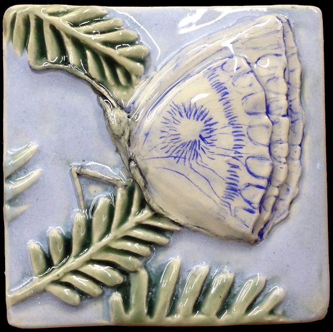 Hand modelled and hand painted feature tile title