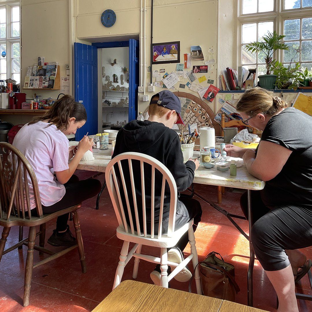 painting ready made pottery in the studio