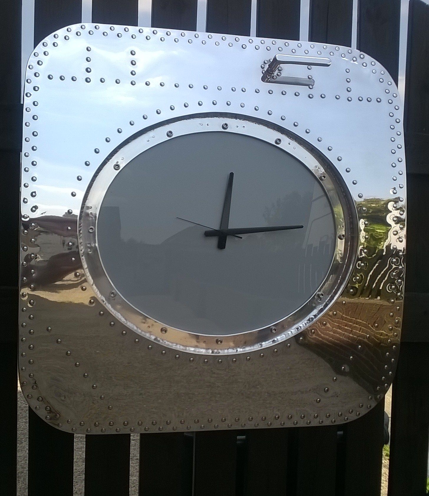 Aircraft window panel now has a mirror-polished reflective shine and a clock in the centre to replace the window panel.