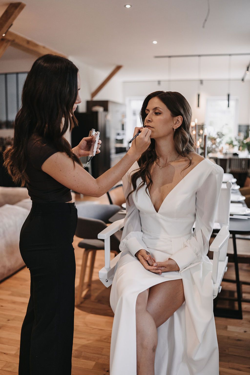 Makeup Artist trägt Lippenstift auf, Getting Ready der Braut beim Brautstyling vor Ort in der Lokation.