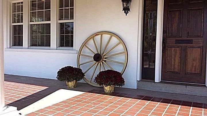 Wagon wheel with 2 burgundy colored mums.