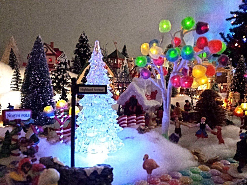 Lit spruce tree with gum drop tree in Santa's Village.