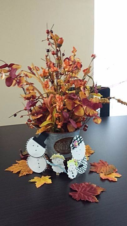 Pail with fall berries and leaves. Our mascots, The Snow Family are also seen .