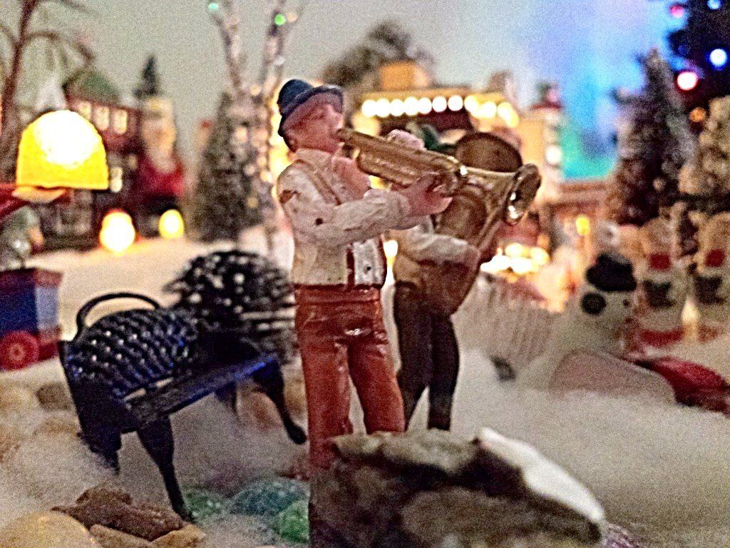 Band plays on. One man playing tuba. One man playing a trumpet.