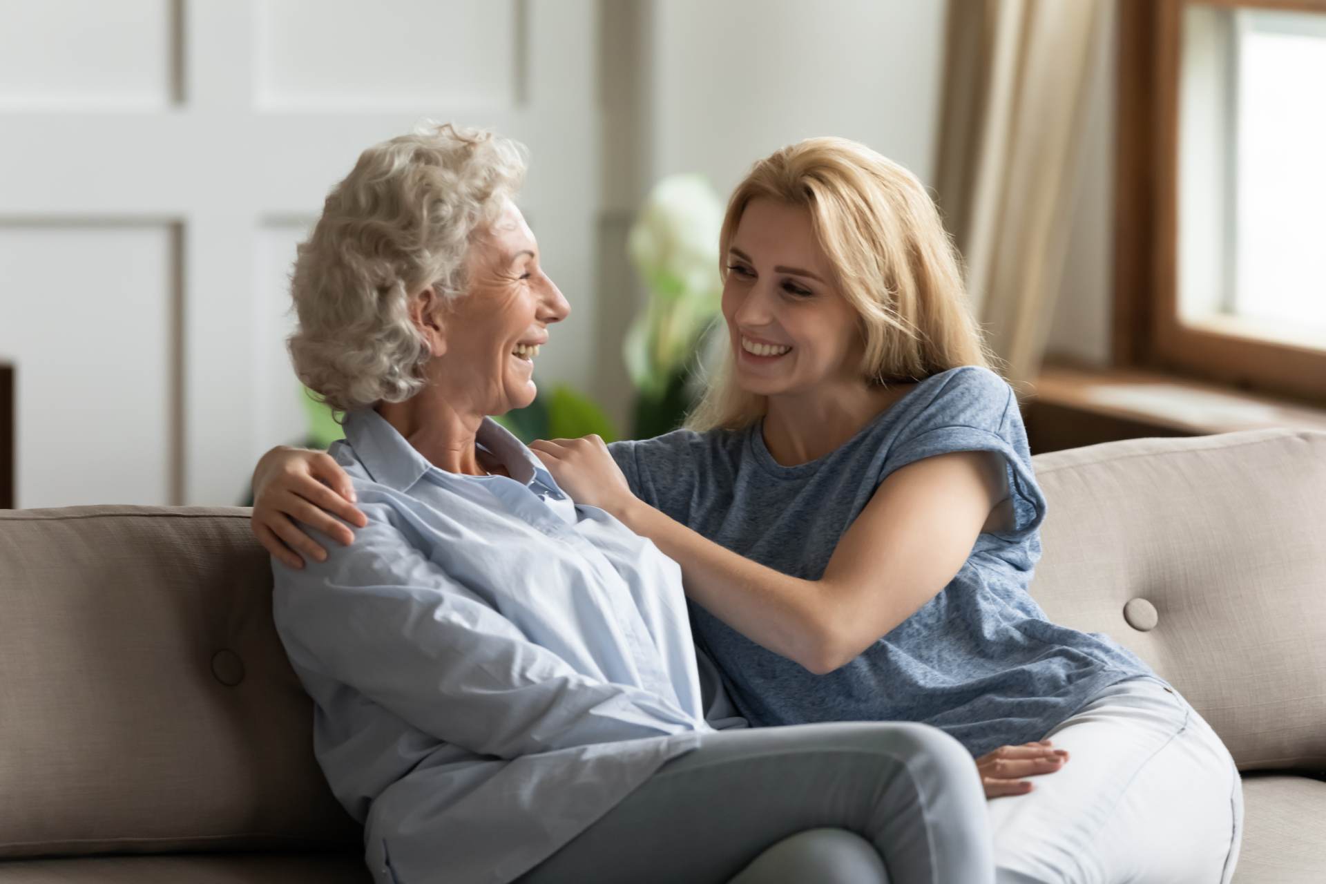a caretaker speaking with an elderly woman
