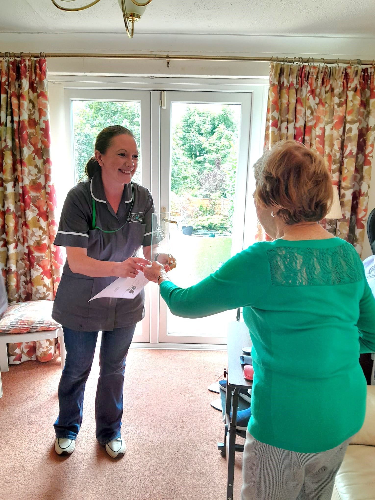 Carer presented by a customer with her 2024 award