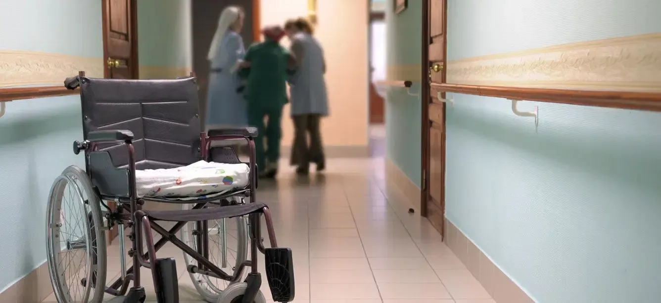 Discarded wheelchair in hospital corridor