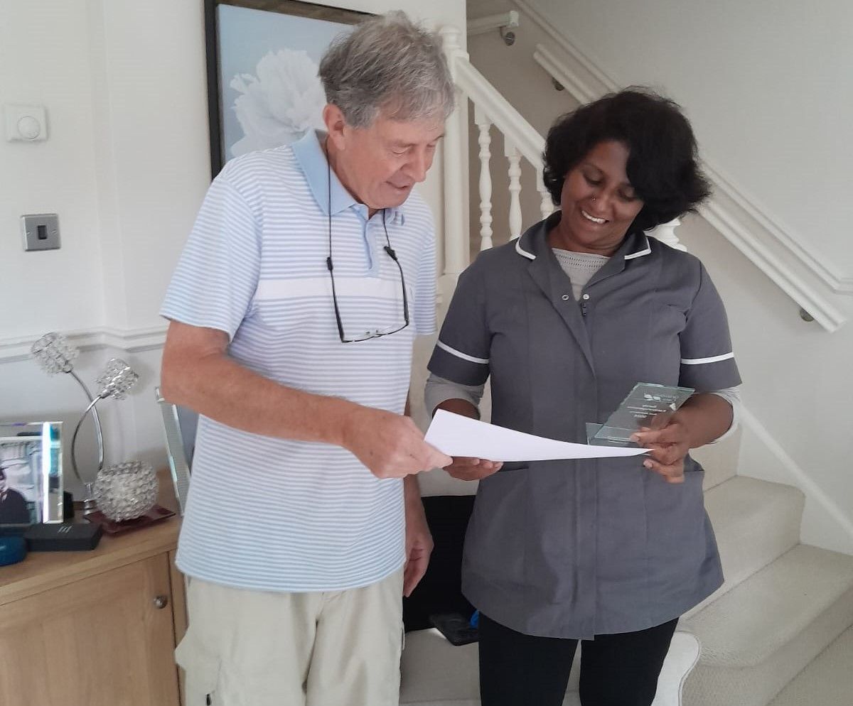 Carer presented by a customer with her 2024 Best Attendance award