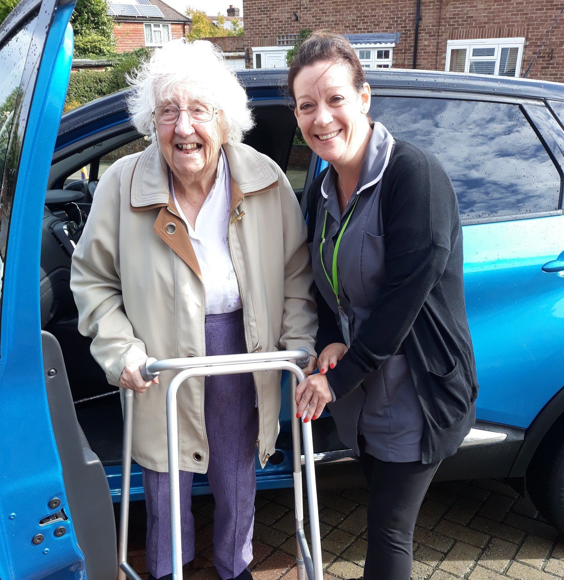 Carer assisting customer home from hospital
