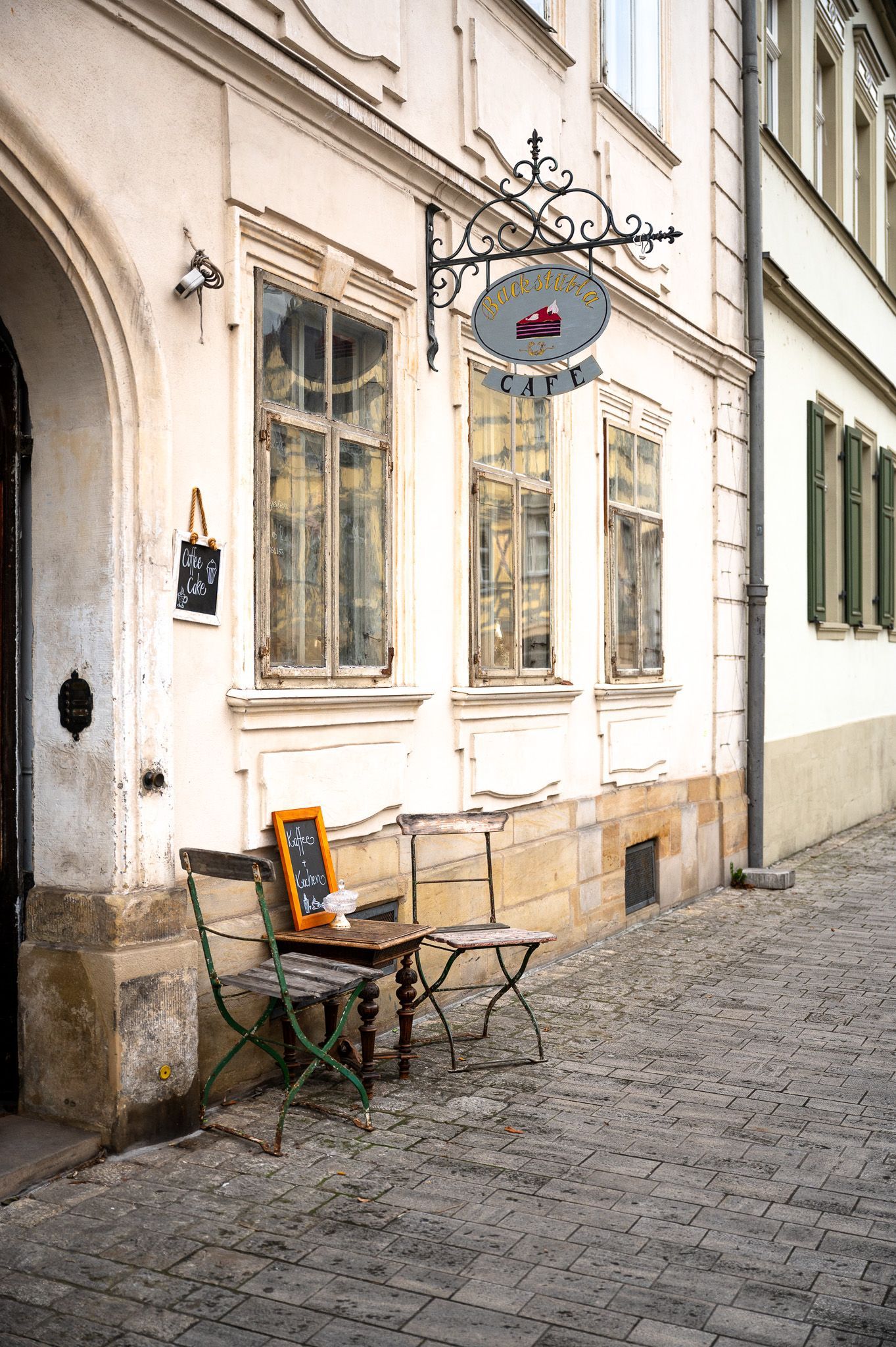 Außenansicht vom Café „Das Backstübla“ in der Altstadt von Bamberg mit nostalgischer Sitzgruppe – Fotowalk-Motiv.