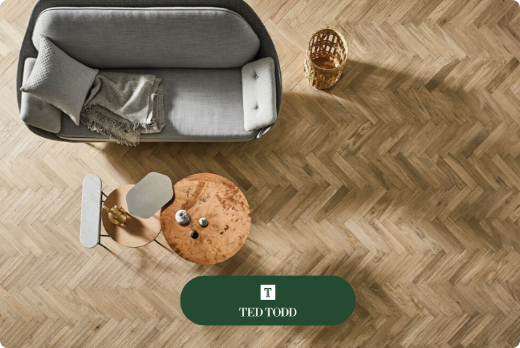 Ted Todd Cotton Herringbone oak floor viewed from above, a small table and two seat sofa in grey