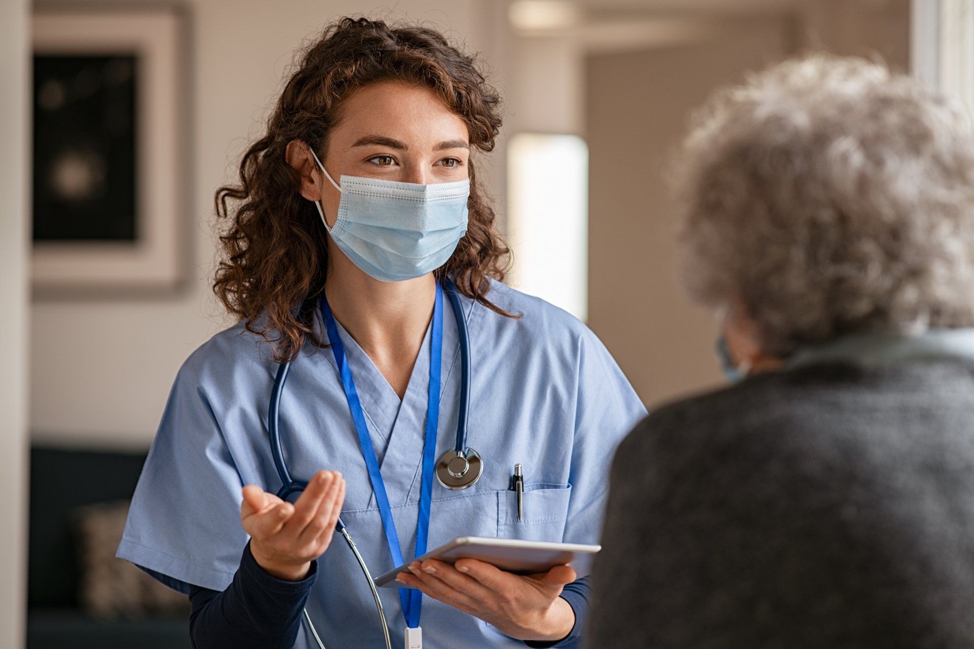 a nurse speaking with an elderly patient