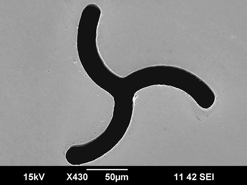 Free-form hole drilled with an ultrafast laser, exit side